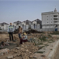 Luxury houses going up in Sen Sok, on the outskirts of Phnom Penh, on Jan. 25. The area has seen a construction boom in the past five years. | NADIA SHIRA COHEN/THE NEW YORK TIMES)