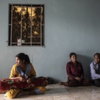 Khuon Savin (left) with her parents in their home in Siem Reap, Cambodia, on Jan. 19. Days before, her husband, Ma Simet, died in a demining accident, Khuon Khai (right) revealed a long-held secret: He had served in the Khmer Rouge.  | NADIA SHIRA COHEN / THE NEW YORK TIMES