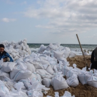 Volunteers fill sand bags at a beach in Odessa, Ukraine, on Wednesday. Nowhere in Ukraine has Russia’s invasion gone to plan, but Moscow’s campaign has progressed enough in the south to show what Putin at least intended. | BLOOMBERG
