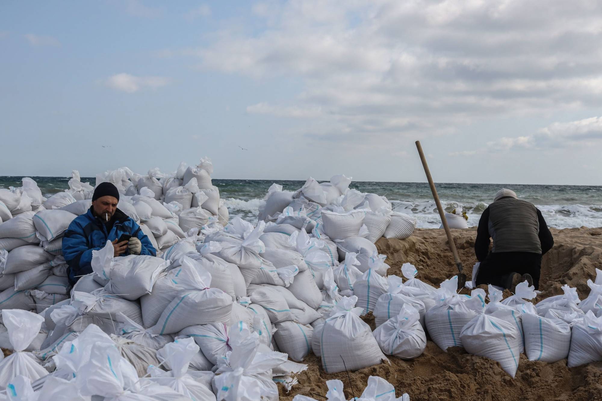 Volunteers fill sand bags at a beach in Odessa, Ukraine, on Wednesday. Nowhere in Ukraine has Russia’s invasion gone to plan, but Moscow’s campaign has progressed enough in the south to show what Putin at least intended. | Bloomberg