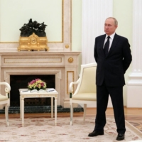 Russian President Vladimir Putin stands in a hall prior to a meeting with his Belarus\' counterpart at the Kremlin in Moscow on March 11. | AFP-JIJI