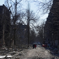 Mariupol residents near damaged residential buildings on Friday  | REUTERS