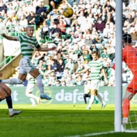 Celtic\'s Daizen Maeda (center) scores the team\'s third goal over Ross County in Glasgow on Saturday. | KYODO