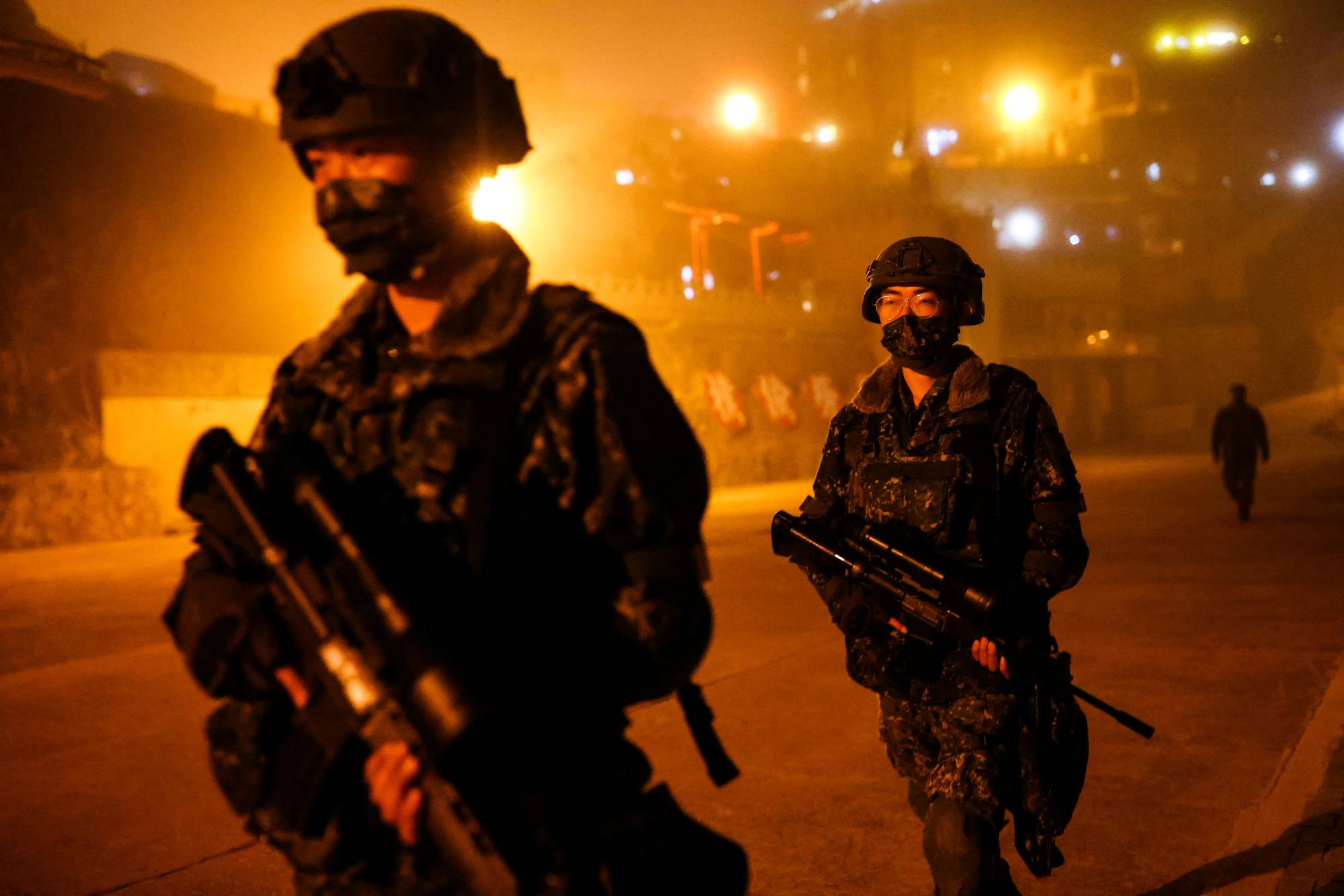 Taiwanese soldiers patrol at night in Dongyin, Taiwan, on Tuesday. | REUTERS