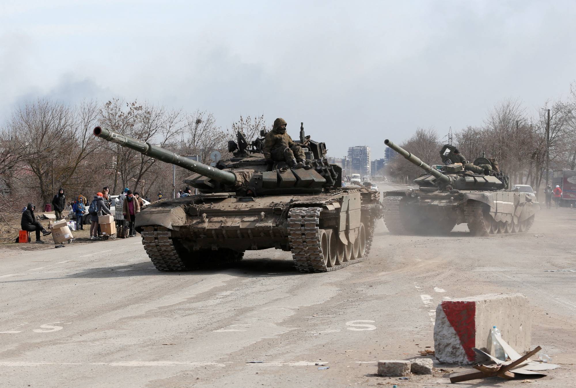 Service members of pro-Russian troops atop of tanks during the Ukraine-Russia conflict on the outskirts of the besieged southern port city of Mariupol, Ukraine, on Sunday. | REUTERS