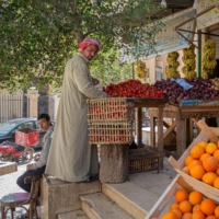 An Egyptian man arranges fruits at a shop in a market in Cairo, on Thursday. Soaring bread prices sparked by Russia\'s invasion of Ukraine have bitten into the purchasing power of consumers in Egypt, a leading importer of wheat from the former Soviet states.  | AFP-JIJI