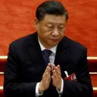 Chinese leader Xi Jinping applauds during the closing session of the National People\'s Congress at Beijing\'s Great Hall of the People on March 11. | REUTERS