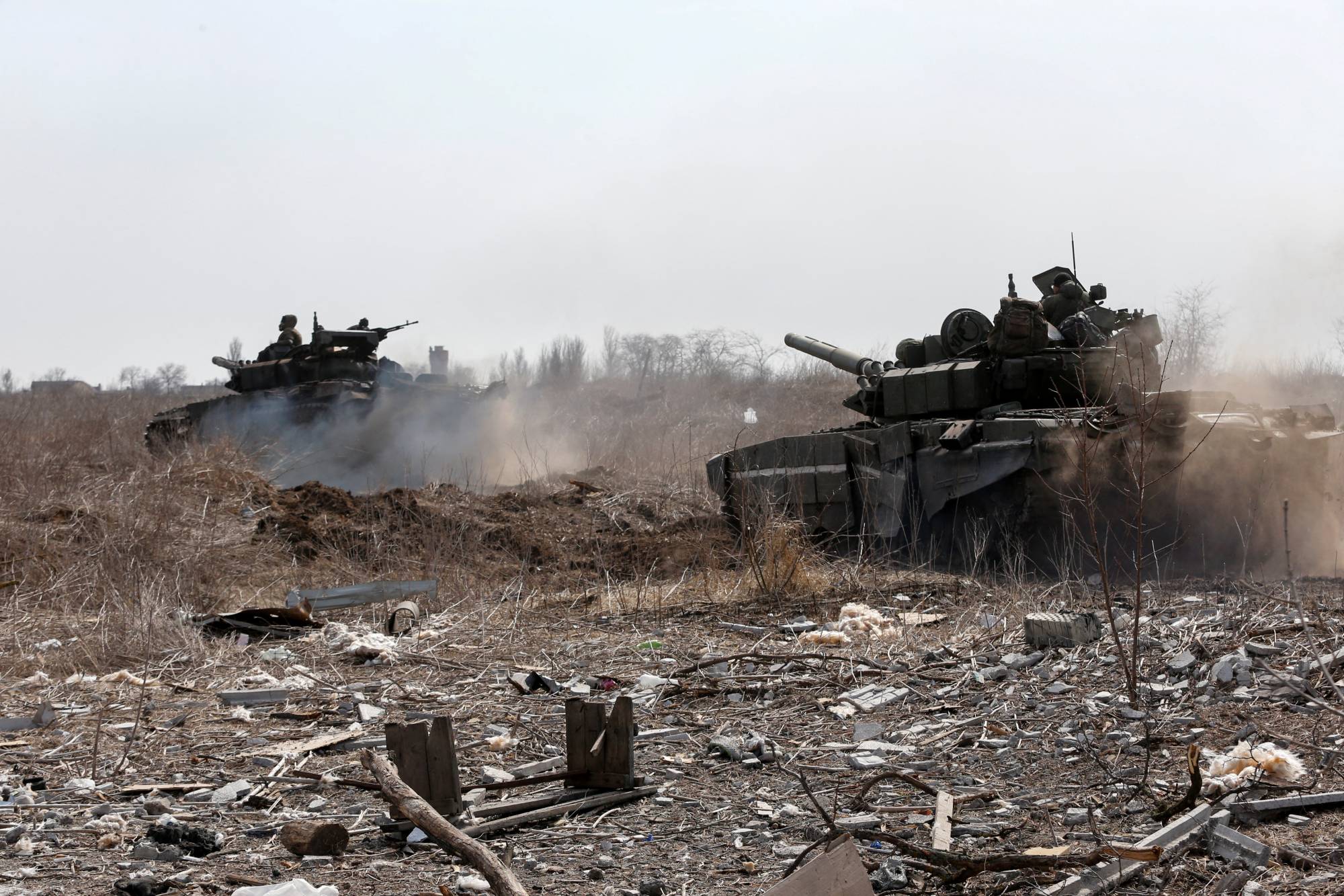 Russian tanks sit on the outskirts of the besieged southern port city of Mariupol, Ukraine, on Sunday. | REUTERS