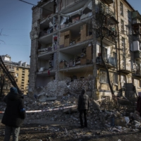 People sift through the remains of a residential complex after a strike in Kyiv, Ukraine, on March 18 | IVOR PRICKETT / THE NEW YORK TIMES