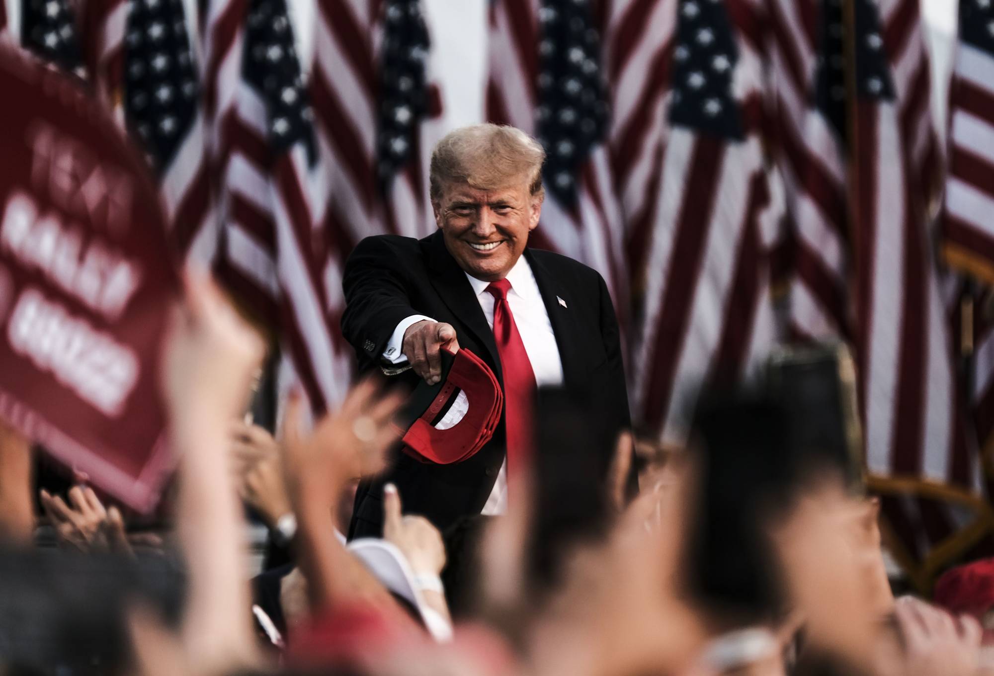 Former U.S. President Donald Trump tosses out MAGA hats and greets attendees during a 'Save America' Rally at the Lorain County Fairgrounds in Wellington, Ohio, U.S., on Saturday, June 26, 2021. | Bloomberg