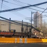Barricades surround an area under lockdown following a COVID-19 outbreak in Shanghai, China, on Thursday. | REUTERS
