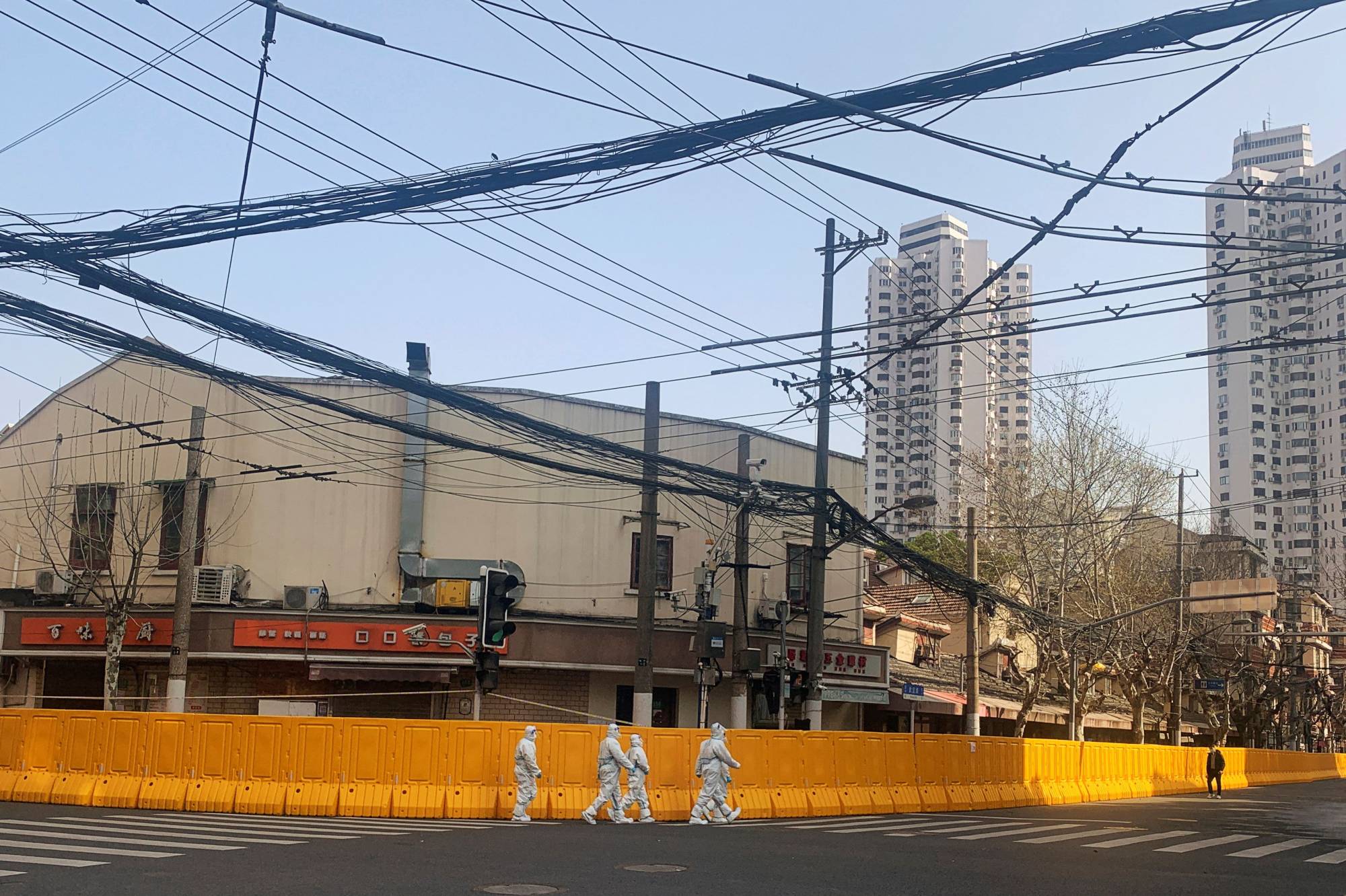Barricades surround an area under lockdown following a COVID-19 outbreak in Shanghai, China, on Thursday. | Reuters