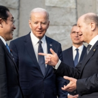 Prime Minister Fumio Kishida, German Chancellor Olaf Scholz and U.S. President Joe Biden meet ahead of a Group of Seven summit in Brussels on Thursday.  | POOL / VIA REUTERS