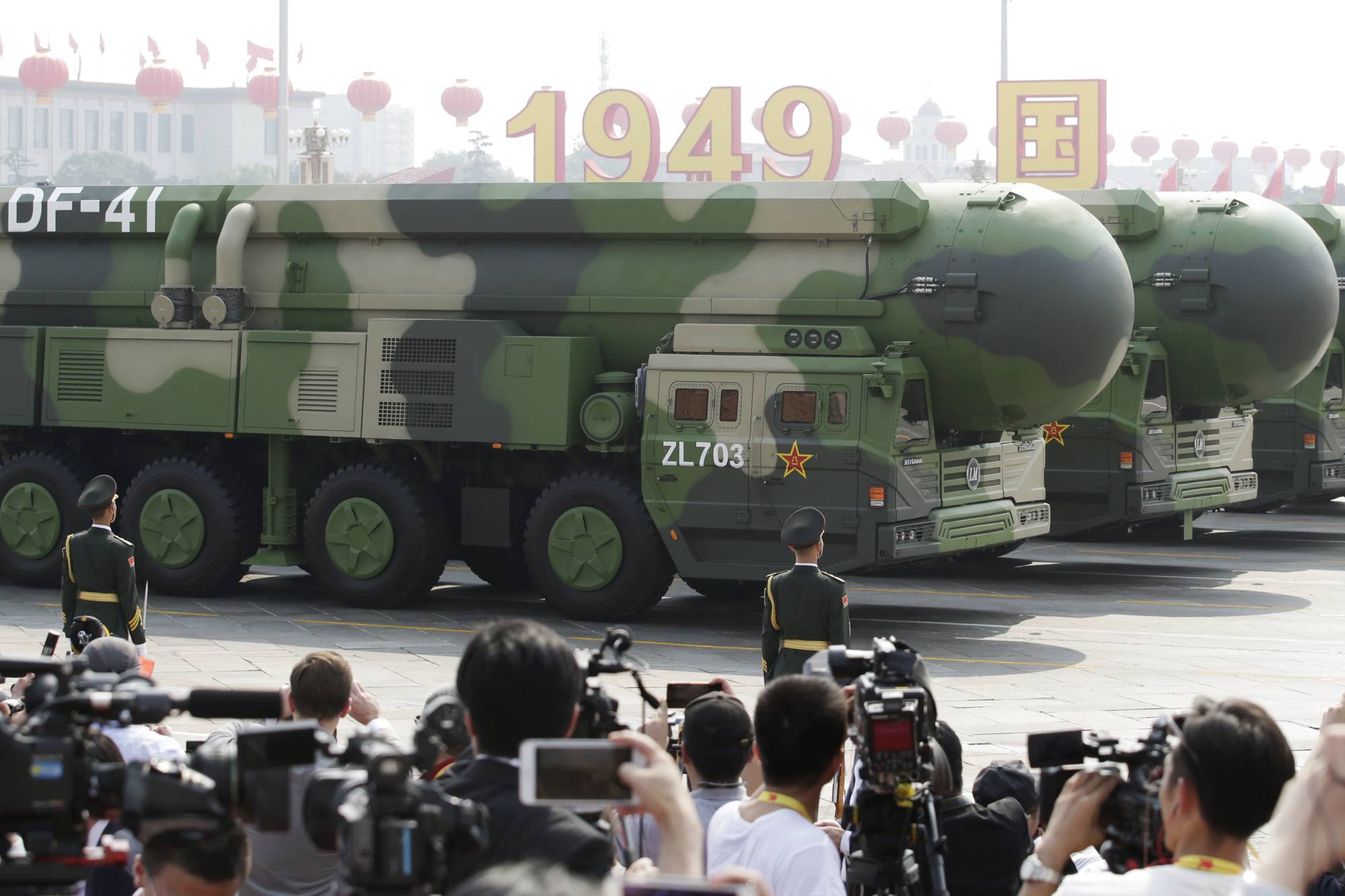 Military vehicles carrying DF-41 intercontinental ballistic missiles travel past Beijing's Tiananmen Square during a military parade in October 2019.  | REUTERS
