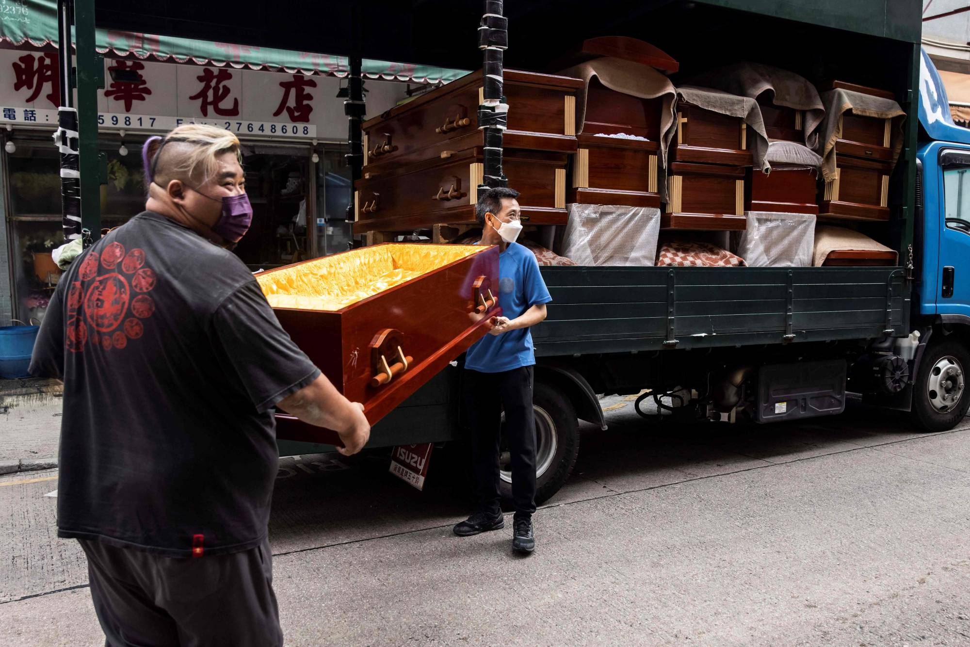 Empty coffins are delivered to a funeral services shop and funeral parlors in the Kowloon district of Hong Kong on March 17 amid the soaring death toll in the city as a result of COVID-19. | AFP-JIJI