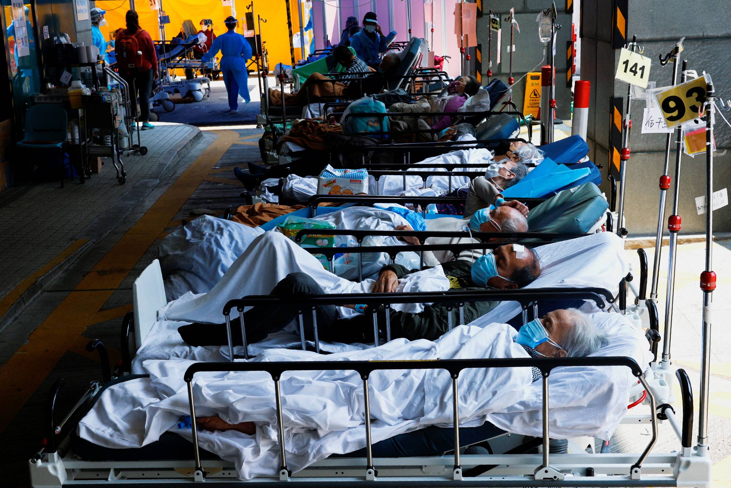 Patients wearing face masks rest at a makeshift treatment area outside a hospital amid the latest coronavirus outbreak in Hong Kong, on March 2. | REUTERS