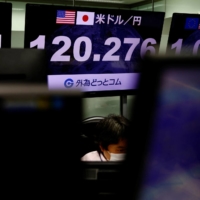 A monitor shows the yen exchange rate against the dollar, in Tokyo on March 22. | REUTERS