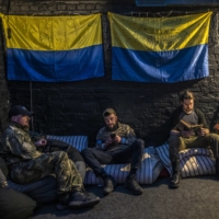 Ukrainian soldiers in Kyiv rest after a day of fighting on the front lines north of the capital city on Monday. | DANIEL BEREHULAK / THE NEW YORK TIMES
