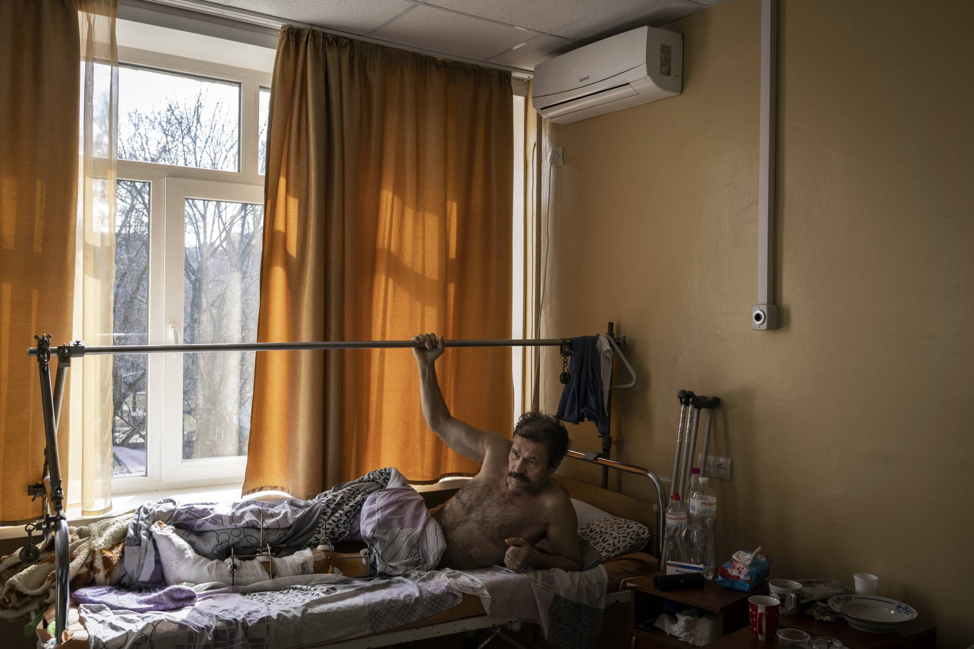 Oleg, 61, recovers in a hospital in Kyiv on Monday after being shot in the leg three times by Russian troops in the nearby suburb of Irpin. | Ivor Prickett / The New York Times