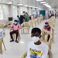Young people wait to receive a dose of a COVID-19 vaccine in Allahabad, India, on March 16. | AFP-JIJI