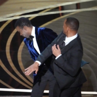 Will Smith slaps Chris Rock after the comedian made a joke about Smith\'s wife, Jada Pinkett Smith, at the Academy Awards in Los Angeles on Sunday. | RUTH FREMSON / THE NEW YORK TIMES