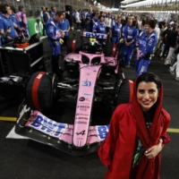 Saudi motor sports enthusiast Aseel Al Hamad poses with the vehicle of Alpine’s Esteban Ocon on the grid before the race at Jeddah Corniche Circuit, in Jeddah, Saudi Arabia, on Sunday. | REUTERS