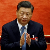 Chinese President Xi Jinping applauds at the opening session of the National People\'s Congress at the Great Hall of the People in Beijing, on March 5. Wariness toward Chinese assets has only increased since Russia attacked Ukraine just weeks after a Beijing summit reinforced the close ties between Xi and Russian President Vladimir Putin. | REUTERS