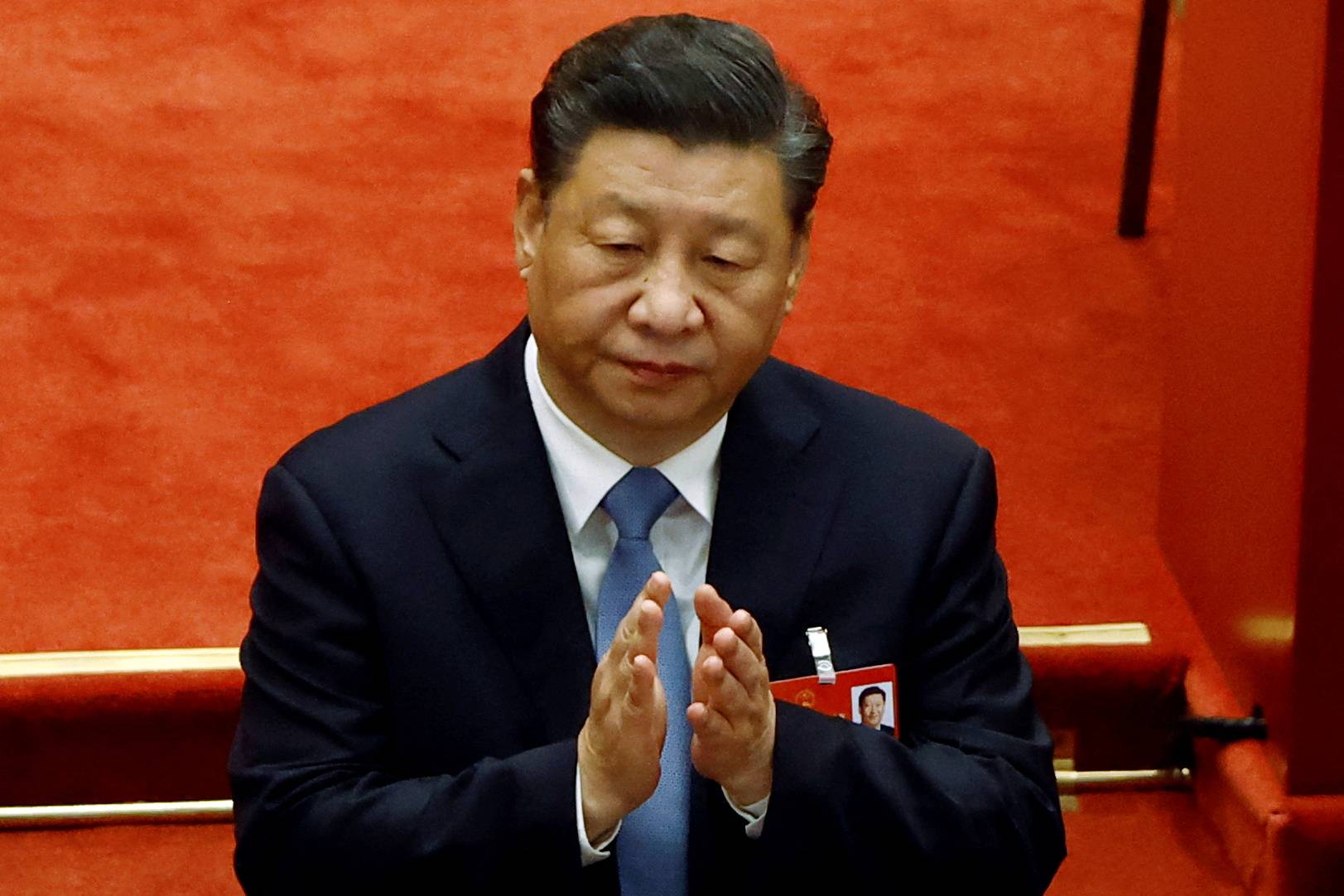 Chinese President Xi Jinping applauds at the opening session of the National People's Congress at the Great Hall of the People in Beijing, on March 5. Wariness toward Chinese assets has only increased since Russia attacked Ukraine just weeks after a Beijing summit reinforced the close ties between Xi and Russian President Vladimir Putin. | REUTERS