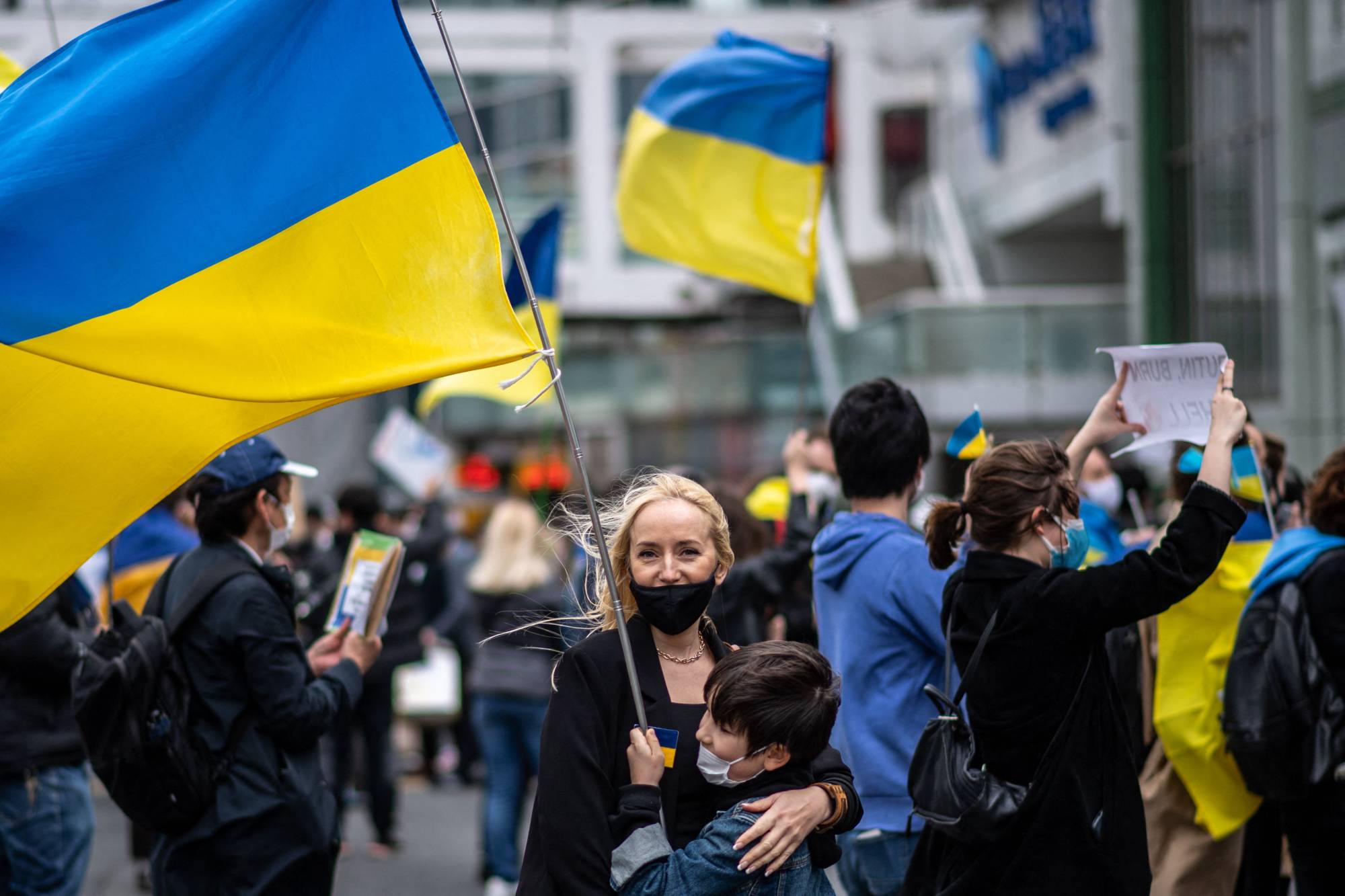 People take part in a fundraising demonstration to support Ukraine in Tokyo's Shinjuku district on Saturday. | AFP-JIJI