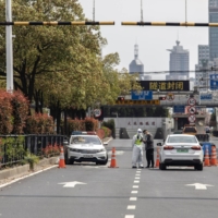 The barricaded entrance to a tunnel leading to the Pudong area, placed under lockdown due to COVID-19, in Shanghai, China | BLOOMBERG