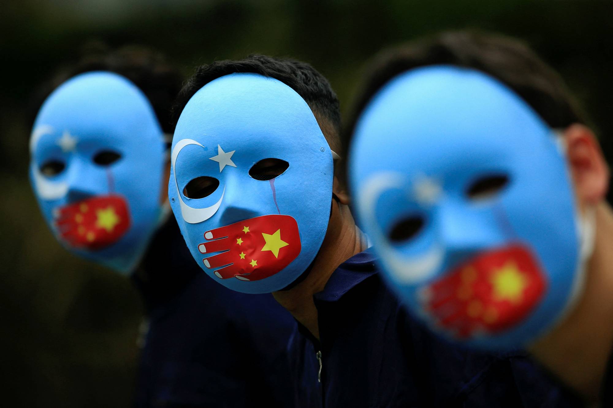 Activists take part in a protest against China's treatment of ethnic Uyghur people and call for a boycott of the 2022 Winter Olympics in Beijing, at a park in Jakarta on Jan. 4. | REUTERS
