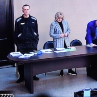 Russian opposition leader Alexei Navalny is seen on a screen via a video link during the verdict in his embezzlement and contempt of court trial at the IK-2 prison colony in Pokrov, Russia, on March 22. | AFP-JIJI