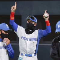 Fighters manager Tsuyoshi Shinjo celebrates after the team\'s won over the Lions at Sapporo Dome on Thursday night. | KYODO