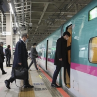 Passengers board a Tohoku Shinkansen train at Sendai Station on Monday as services between Sendai and Ichinoseki resumed the same day. | KYODO