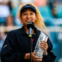 Runner up Naomi Osaka receives a trophy following the women’s single finals at the 2022 Miami Open in Florida on Saturday. | AFP-JIJI