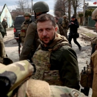 Ukrainian President Volodymyr Zelenskyy visits the town of Bucha, outside Kyiv, on Monday, days after Russian forces withdrew from the area, leaving a trail of carnage behind. | REUTERS