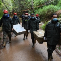 A search team at the site where China Eastern flight MU5375 crashed in Guangxi province, China, on March 24 | AFP-JIJI