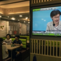News coverage of Carrie Lam, the chief executive of Hong Kong, on a television at a restaurant in Hong Kong on Wednesday.  | LAM YIK FEI / THE NEW YORK TIMES