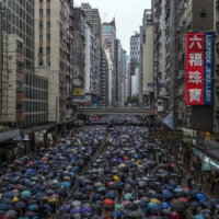 Demonstrators demanding the resignation of Carrie Lam, the chief executive of Hong Kong, pack a street in Hong Kong in 2019.  | LAM YIK FEI / THE NEW YORK TIMES