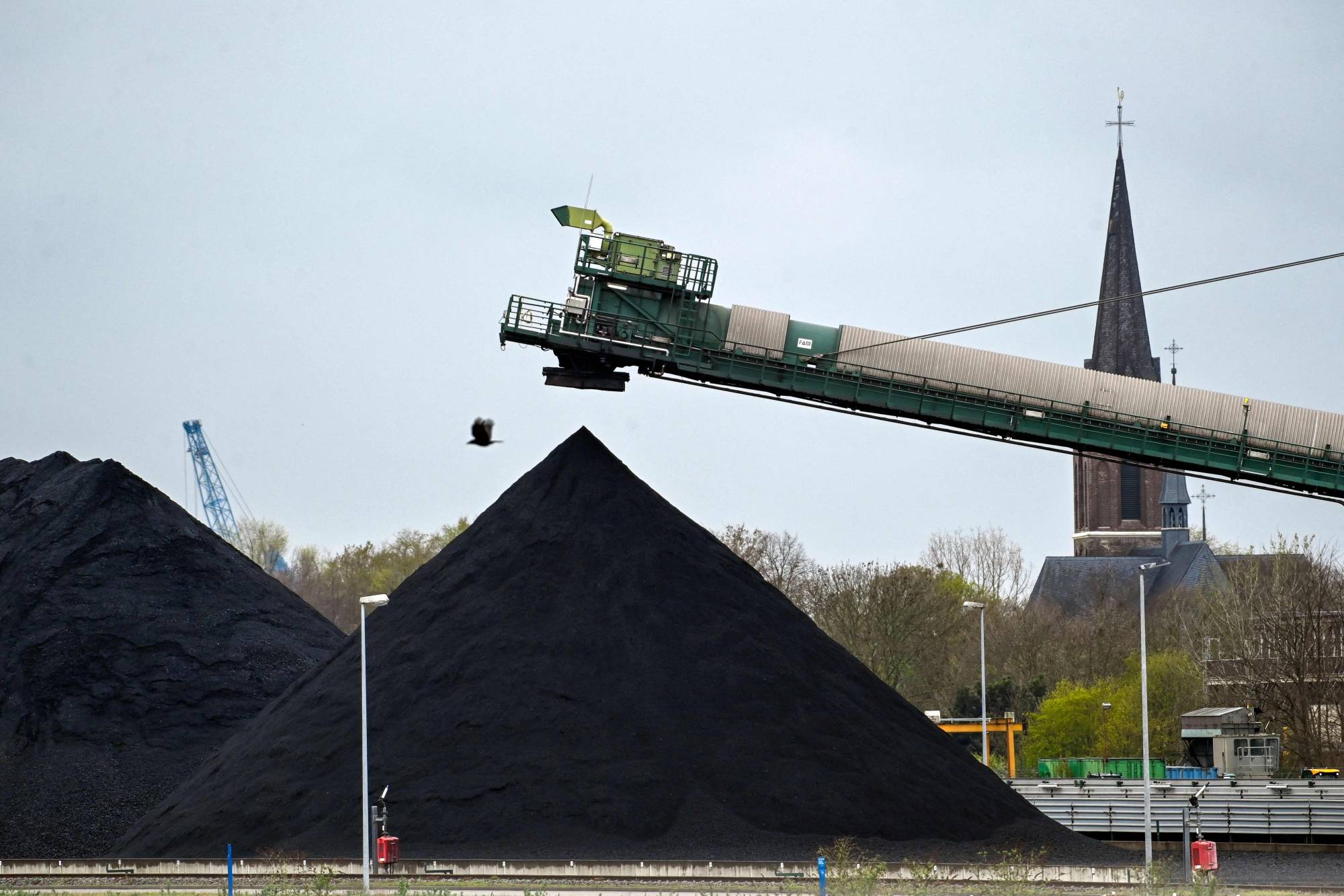 Hard coal reserves at German energy supplier Steag's coal-fired power plant in Duisburg, Germany, on Tuesday. A new sanctions package prepared by the European Union against Russia is set to include oil and coal. | AFP-JIJI