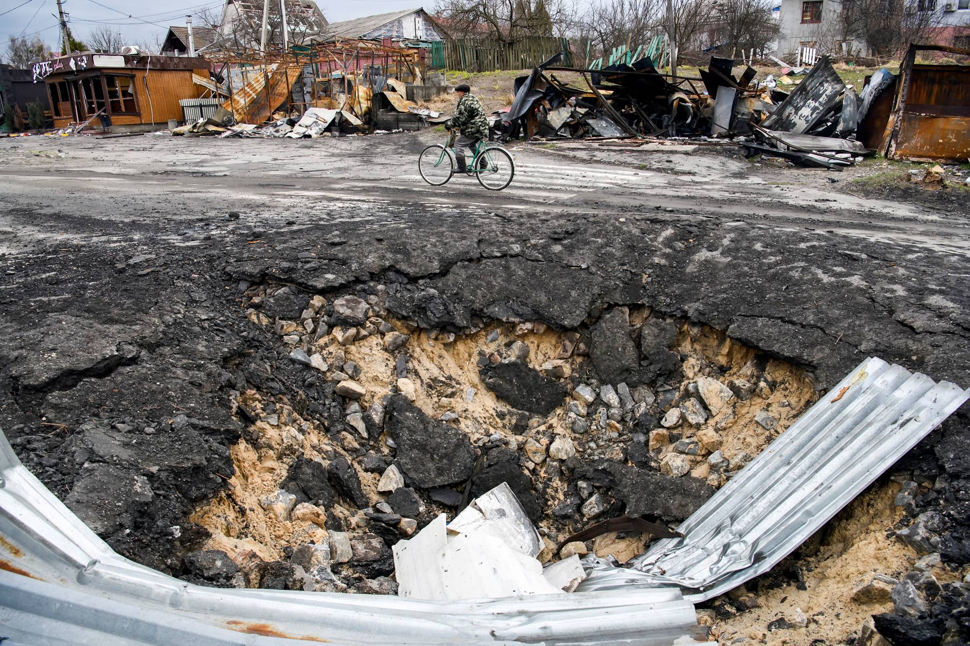 A bomb crater in the village of Demydiv, outside Kyiv, on Wednesday  | REUTERS 