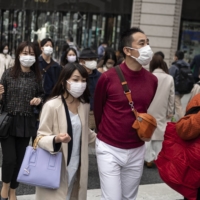 Tokyo\'s Ginza district on March 19. The seven-day average of new COVID-19 infections nationwide stood at 46,594 as of Tuesday, up from 43,250 the week before and increasing for two weeks in a row. | AFP-JIJI
