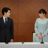 Princess Mako and her husband Kei Komuro attend a news conference to announce their wedding in Tokyo in October. | POOL / VIA REUTERS
