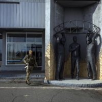 A Ukrainian soldier outside the main station at the Chernobyl nuclear plant in Ukraine on Thursday. | IVOR PRICKETT / THE NEW YORK TIMES