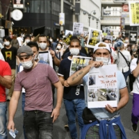 Demonstrators, including foreign residents, take to the streets in Tokyo\'s Shibuya Ward in May 2020 to protest against the alleged mistreatment by Japanese police of a Kurdish man. | KYODO