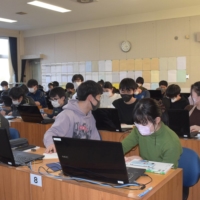 Male and female students attend a class together at Sendai Daini High School in January. The school became coed in 2007. | KAHOKU SHIMPO 