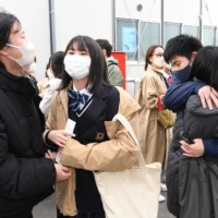 Students express joy and relief after seeing the results of their entrance exam at Miyagi First High School in March. | KAHOKU SHIMPO
