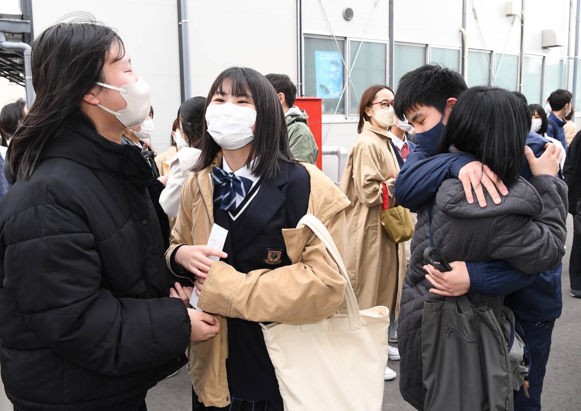 Students express joy and relief after seeing the results of their entrance exam at Miyagi First High School in March. | KAHOKU SHIMPO