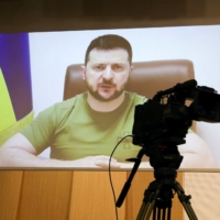 Ukrainian President Volodymyr Zelenskyy addresses South Korean parliament via video link at the National Assembly in Seoul on Monday. | POOL / VIA REUTERS