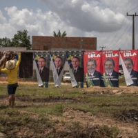 A street vendor sells towels with images of Jair Bolsonaro, Brazil\'s president, and Luiz Inacio Lula da Silva, Brazil\'s former president, near Eldorado dos Carajas, Para state, Brazil, on Sept. 30. | BLOOMBERG